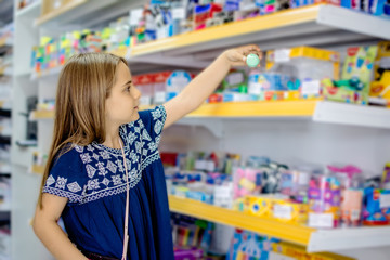 Child girl looking for products in store
