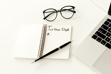 Writing a plan for work in a notebook. Business concept - work in a bright modern office