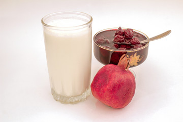 Cherry cherry jam and a glass of milk.