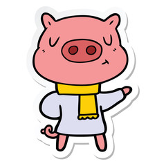 sticker of a cartoon content pig in winter attire