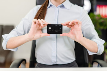 Young businesswoman making online payments using credit card and internet on the laptop in the...