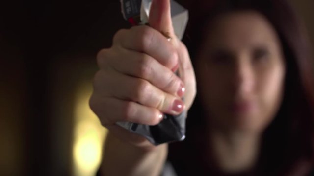 Close up female hands crushing a pack of cigarettes