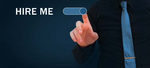Hire me, give me a job, find a job, looking for a job concepts. Businessman switching on button hire me on virtual screen