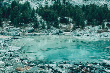 Mountain lake, rocks are reflected in water surface