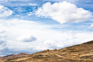 Mountain valley under clouds. Summer day among hills