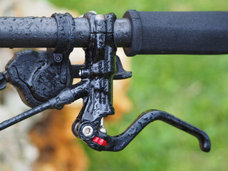 wet black bicycle handlebar with many water drop.
