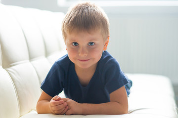 Portrait of happy smiling boy. Attractive kid at home.
