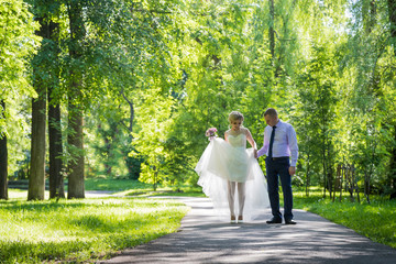 Fototapeta premium Russian bride and groom together in green city park