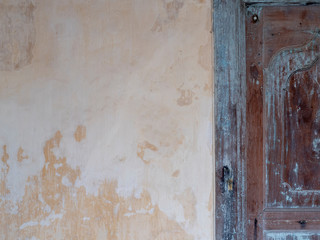 Background, texture of old plaster and painted wood. shutters on the facade
