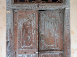 Background, texture of old plaster and painted wood. shutters on the facade