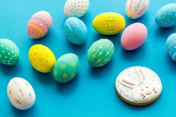 Colorful Easter eggs background and gingerbread on blue