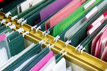 Files document of hanging file folders in a drawer in a whole pile of full papers, at work office...