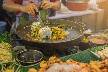 Local street food stalls making Pad Thai in Bangkok Thailand.