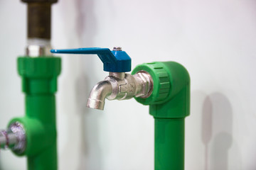 Blue faucet and Green Pipes installed at home  