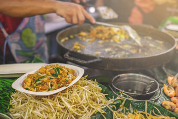 Local street food stalls making Pad Thai in Bangkok Thailand.