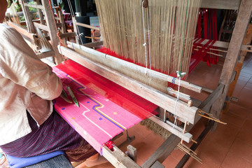 worker girl weaving the ancient Loom