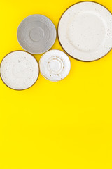 Mockup with plates. Empty ceramic plates on yellow background top view copy space