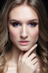 Female with wavy hair on black background