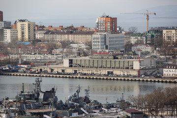 2013 - Sea facade in the capital of the Far East, the city of Vladivostok. Sea trading port with ships. Drifting ships in the raid.	