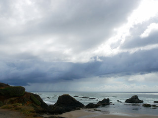 Fototapeta na wymiar Rainy beach with the sun starting to peek through on west coast of USA