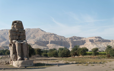 Egypt. Luxor. The Colossi of Memnon - massive stone statue of Pharaoh Amenhotep III - obrazy, fototapety, plakaty