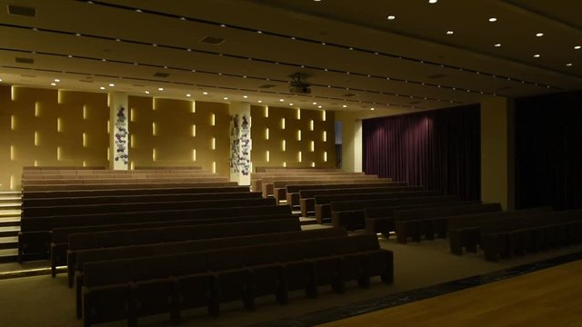 Light switched on/off, in empty conference hall with rows of seats for spectators and audience. Big empty modern meeting,seminar,conference room