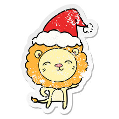 distressed sticker cartoon of a lion wearing santa hat
