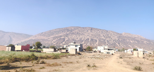 Agriculture and architecture around the Aravalli range in Rajathan, India.