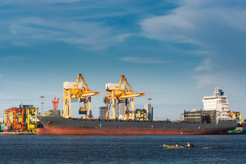 Fototapeta premium Transportation and Shipping Logistics Loading Dock Terminal., Container Import and Export of Sea Freight Transport Industrial., Landscape of Port Maritime and Harbor Cargo Shipyard With Crane Bridge.