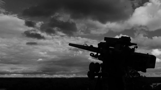 silhouette of a world war 2 cannon time lapse