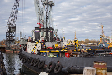 Fototapeta premium Tugboats and other marine support vessels in port.