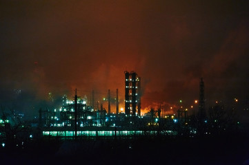 Fototapeta na wymiar Glitter lighting of petrochemical plant with night, Manufacturing of petroleum, Products tank in petrochemical plant. Oil refinery at twilight