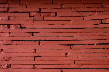 Red stone wall background, detail of a fireplace