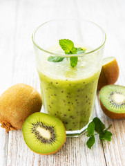 Naklejka na ściany i meble Glass of kiwi smoothie with fresh fruits