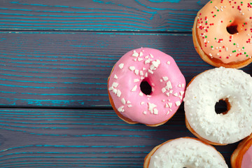 Glazed donuts on wooden background