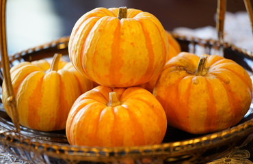 Many pumpkins which were displayed in the basket on the table