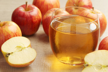 A glass with juice and apples