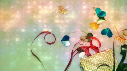 Colourful heart shape ribbon with small gift boxes on colorful bokeh, flare background.