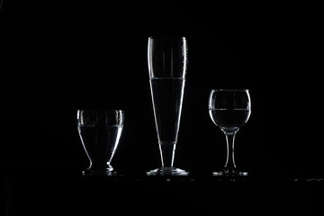 set of transparent glasses on black background 