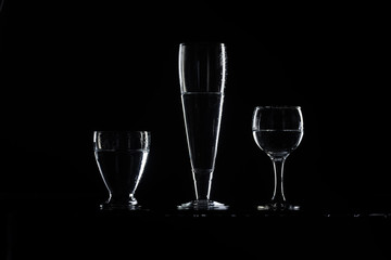 set of transparent glasses on black background 