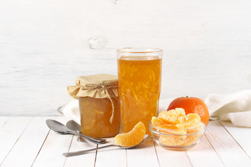 Citrus jam in glass jars and orange slices