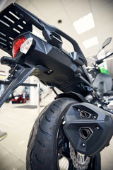View of the back of a motorcycle with an emphasis on the chain.
