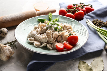 Plate with tasty dumplings on table