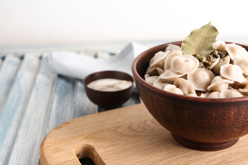 Bowl with tasty dumplings on table