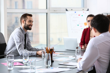 Young people having business meeting in office