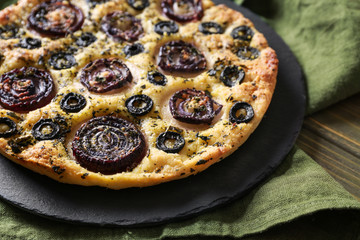 Slate plate with tasty Italian focaccia on table