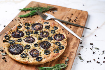 Wooden board with tasty Italian focaccia on light table