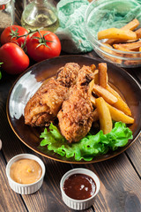 Crispy fried kentucky chicken legs with french fries