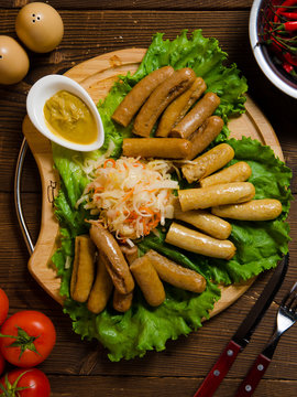fried sausages on wooden table top view