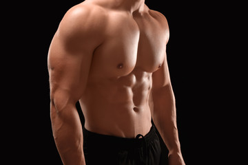 Fototapeta na wymiar Muscular bodybuilder on dark background